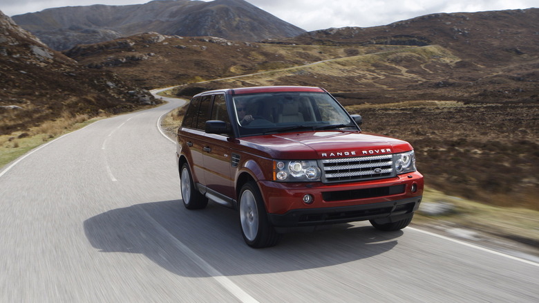 A red first-generation Range Rover Sport, front 3/4 view