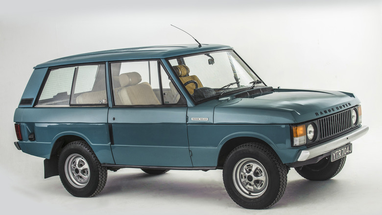 A Range Rover Classic in dark teal, front 3/4 view