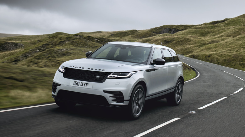 A silver Range Rover Velar on the move, front 3/4 view