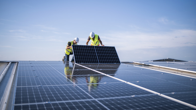 workers installing solar panels