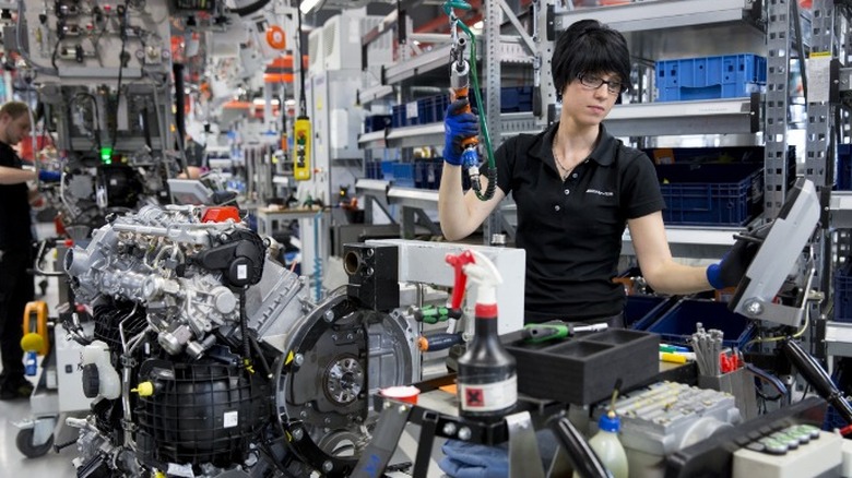 Worker on engine assembly line