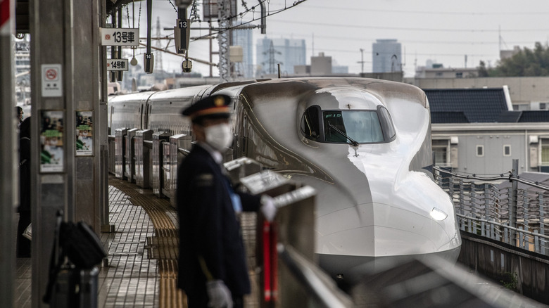 Shinkansen bullet train pulling into station in Tokyo