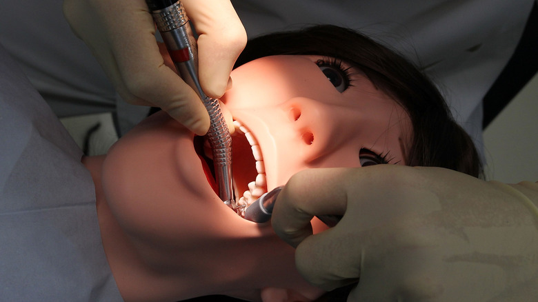 dentist operates on humanoid figure