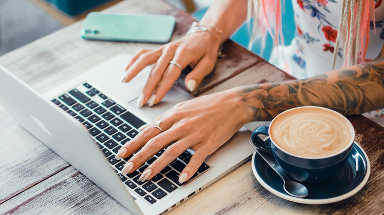 woman using macbook and iphone