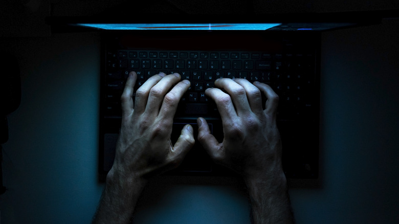 hands on keyboard in darkness