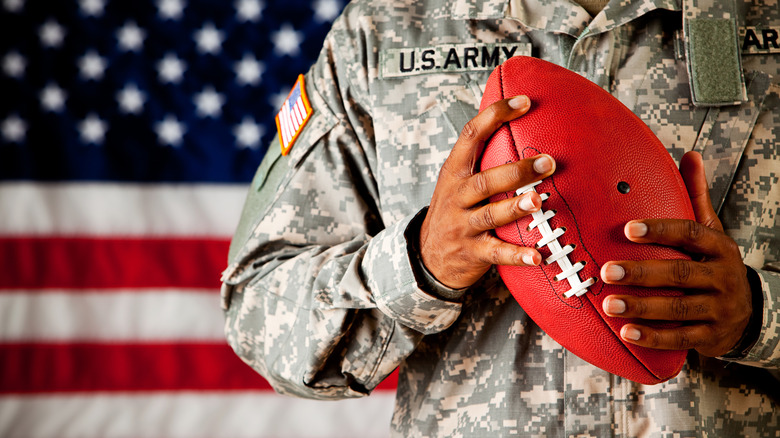 US soldier holding a football