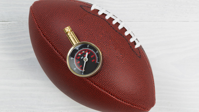 football with air pressure gauge