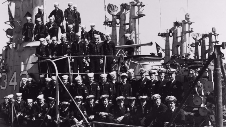 The crew of the USS Chopper posed on the ship's dorsal