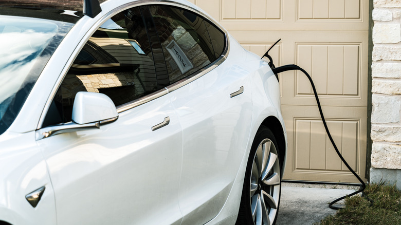 The Model 3 charges outside a home