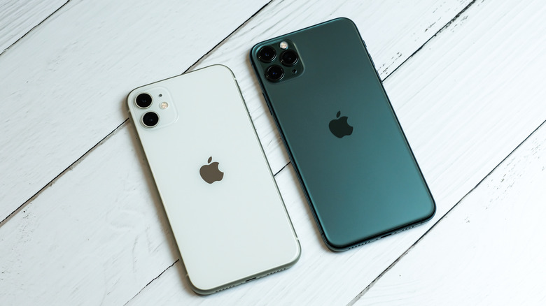 iPhone 11 in white and 11 Pro in midnight green