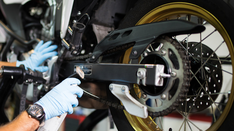 Person working on motorcycle