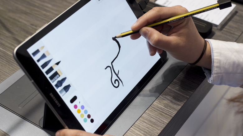 Person using a stylus on a Samsung tablet