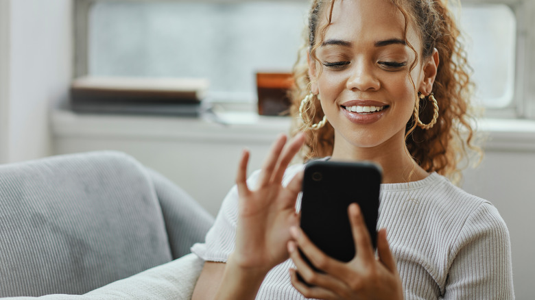 woman downloading app on phone