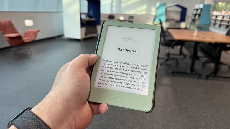 Man holding an Amazon Kindle