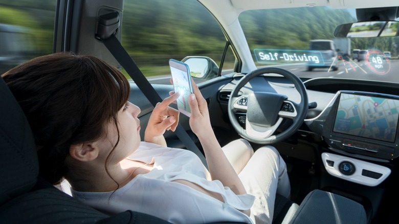woman playing game self-driving car