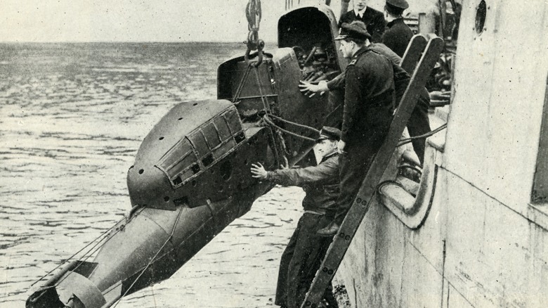 Soldiers launching manned torpedo into sea