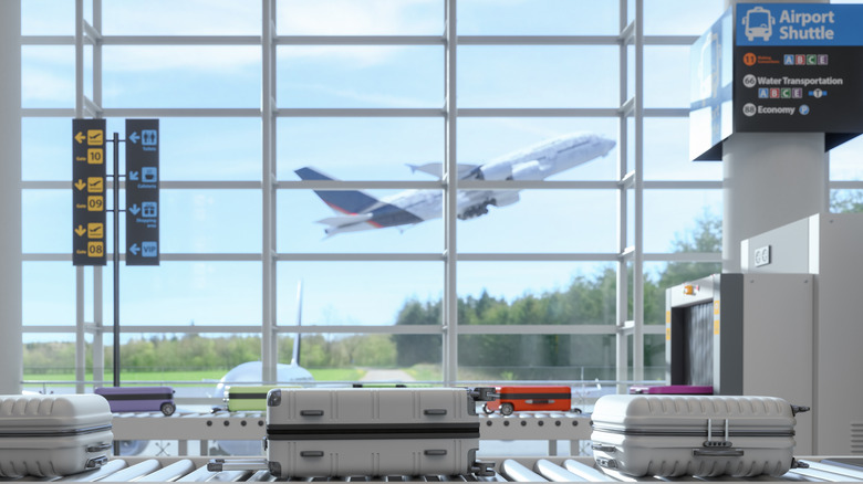 An airplane in flight, seen through an airport window.