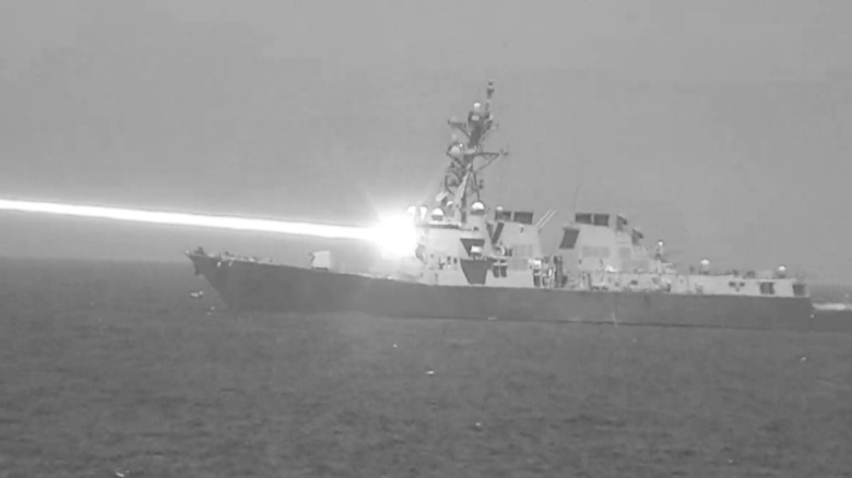 Yhe USS Preble fires its HELIOS laser system in an undated FY2024 Navy photo.