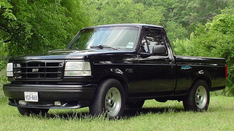 Black 1993 F-150 SVT Lightning parked grass