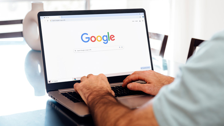 Man using Google search on a laptop