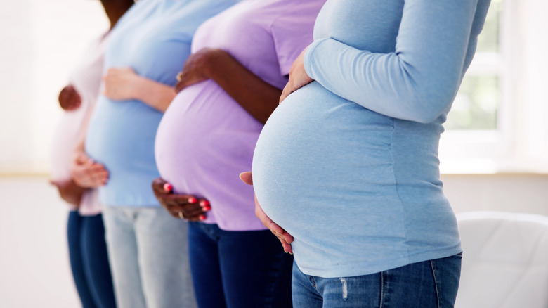 Pregnant women standing next to each other