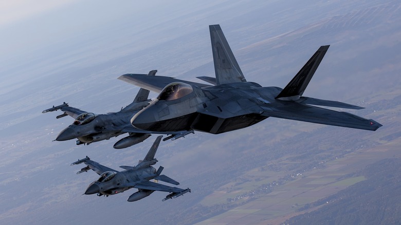 Three F-22 Raptor fighter jets in air formation