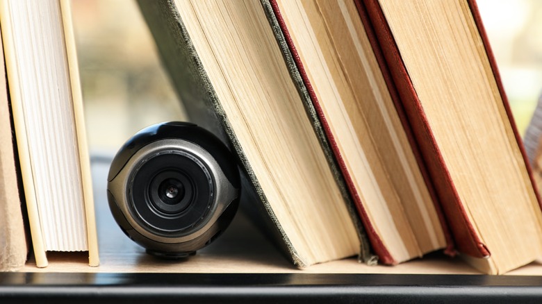camera hidden between books