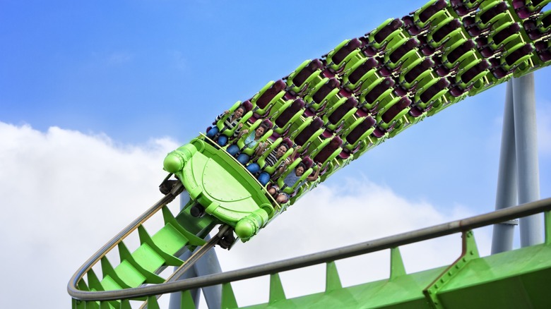 people in a green roller coaster