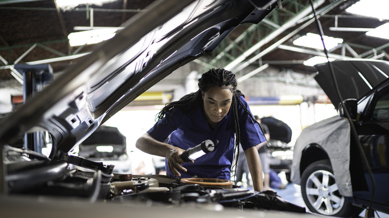 Looking under hood of car