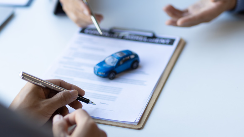 A toy car over an image of paperwork