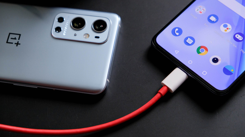 oneplus smartphone connected to charger