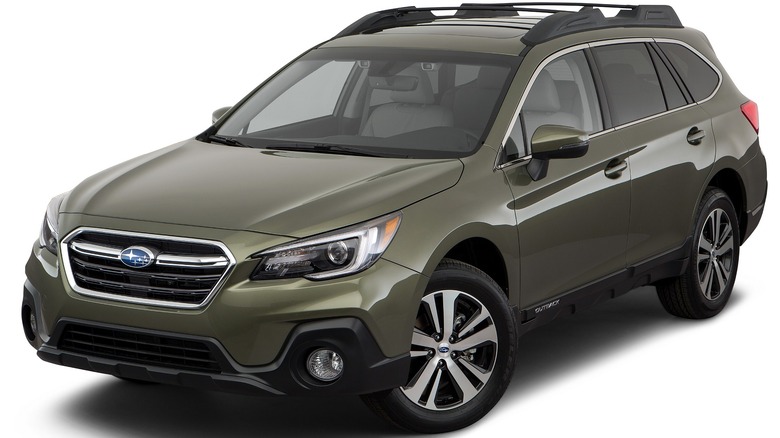 2018 Subaru Outback In Green With A White Background And Wheels Turning To The Right