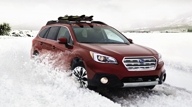 2017 Subaru Outback In Red With Roof Rack Driving In the Snow