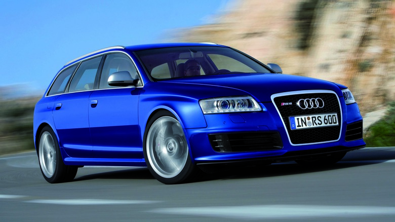 The C6 Audi RS6 Avant in blue driving, front 3/4 view