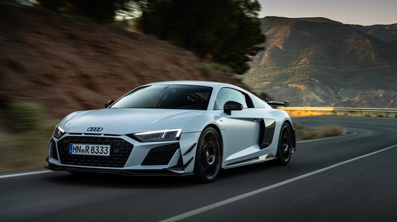 The Audi R8 GT in white driving, front 3/4 view 