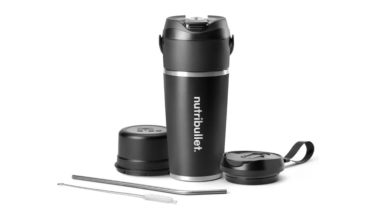 Black cup-like blender with matching lids and a straw and brush