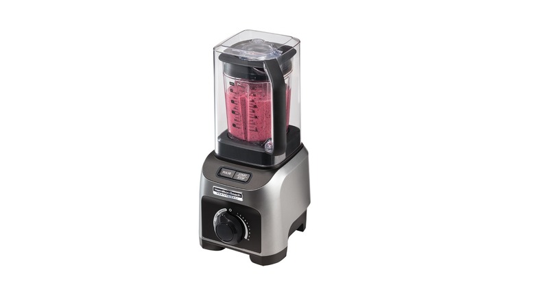 Blender with plastic enclosure containing a pink smoothie