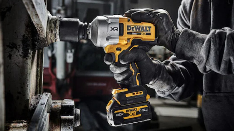 person using Dewalt impact wrench on fastener