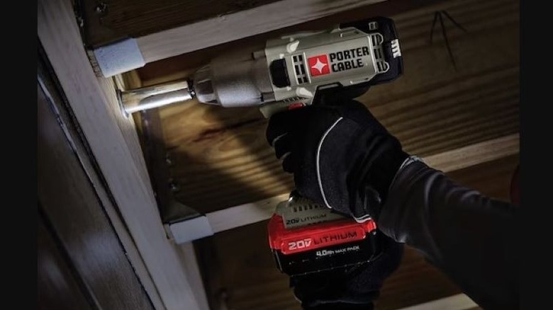 Person using Porter-Cable impact wrench under deck