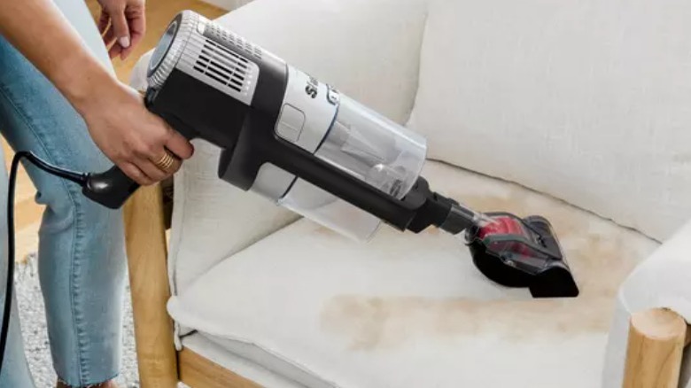 Shark Stratos vacuum cleaning a chair