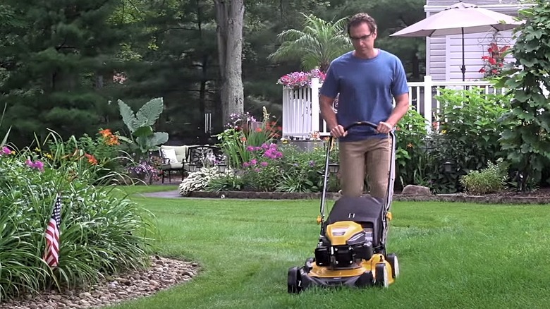 A man cutting his lawn with the Cub Cadet CC 800.