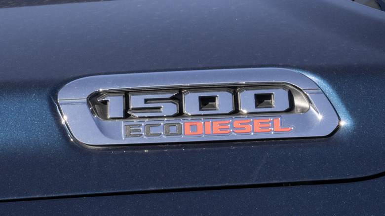 The Ram 1500 EcoDiesel badge on the hood of a gray Ram 1500 truck.