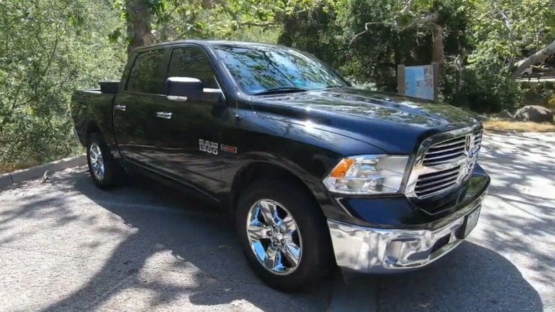 A black 2016 RAM 1500 EcoDiesel truck parked outside.