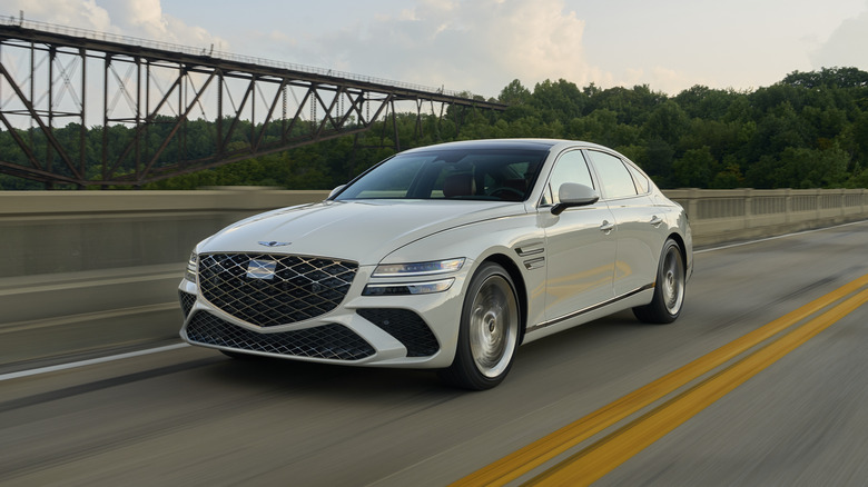 white Genesis G80 driving down the freeway