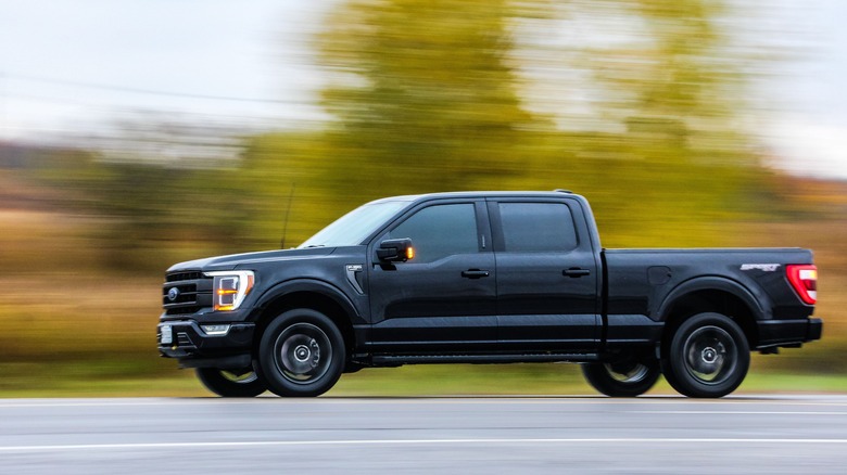 black Ford F-150 driving highway