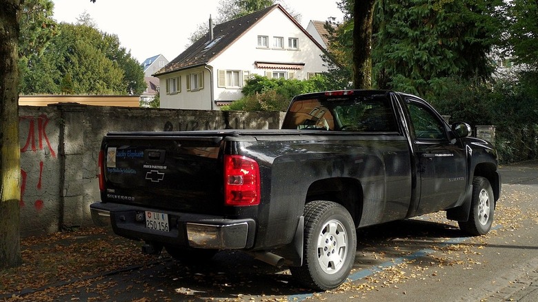 Black Chevrolet Silverado wall with graffiti