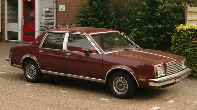 A 1980 Buick Skylark sedan parked in front of a business