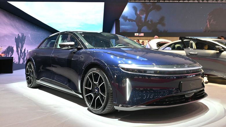 The Lucid Air Sapphire at an auto show floor, front 3/4 view