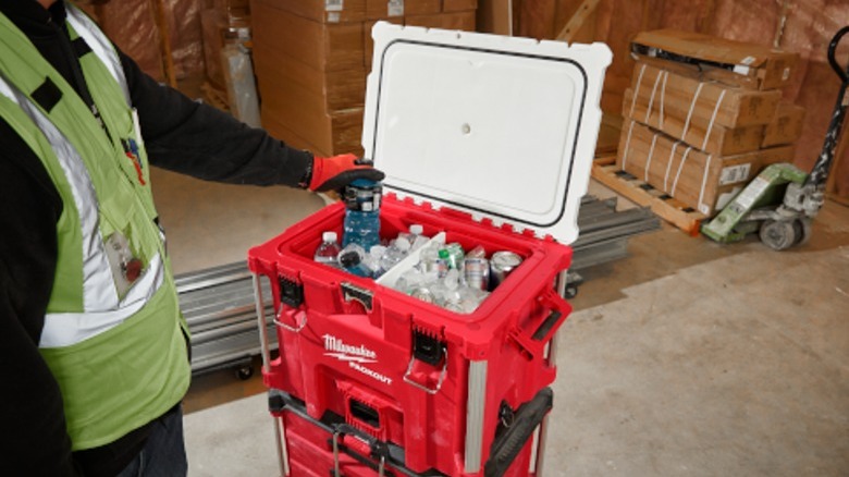 Person taking drink from cooler