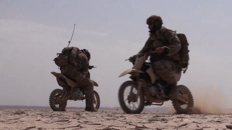 Soldiers riding Kawasaki KLX110 motorcycles